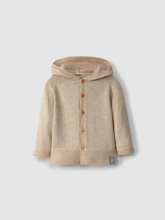 Knitted jacket with hood and pom-pom