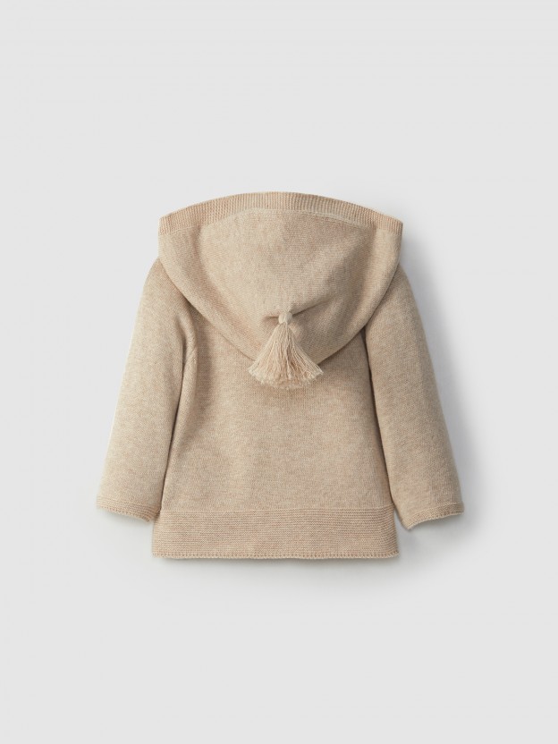 Knitted jacket with hood and pom-pom
