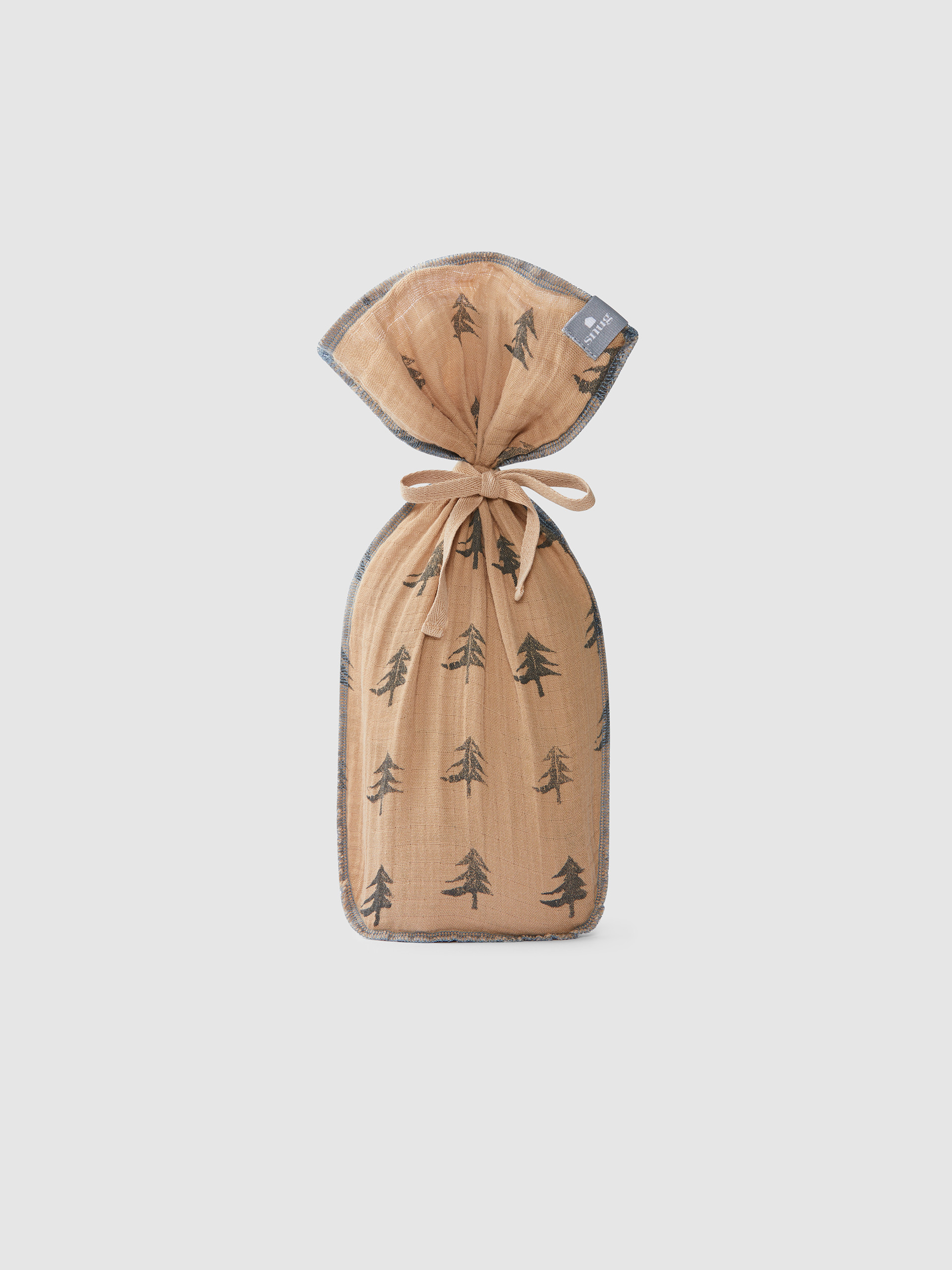 Pine trees swaddle in muslin