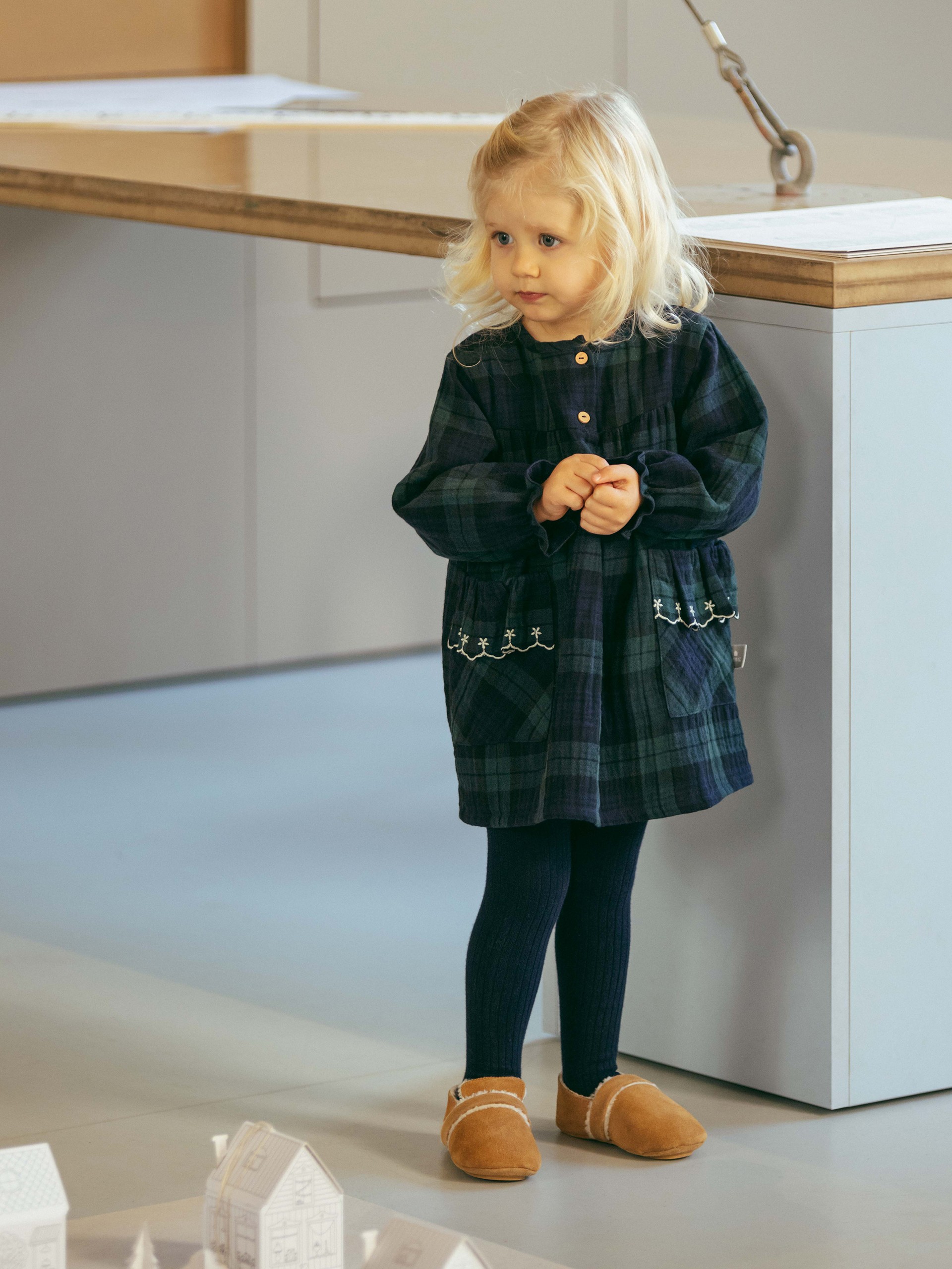 Check dress with embroidered ruffled pocket detail