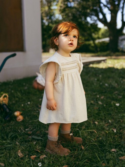 Dress with plaited ribbon detail