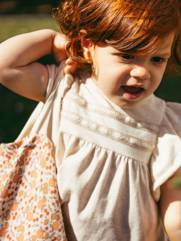 Dress with plaited ribbon detail