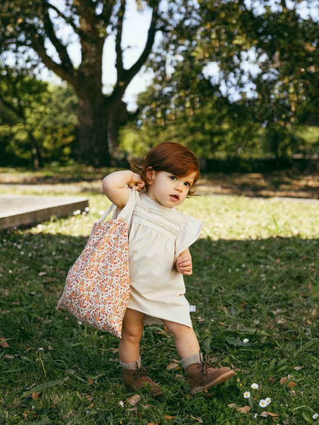Dress with plaited ribbon detail