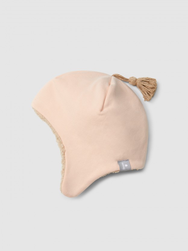 Beanie in plush with pom-pom and fur interior